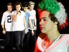 Harry Styles covers his famous locks with a curly Italian flag wig as One Direction perform in Verona